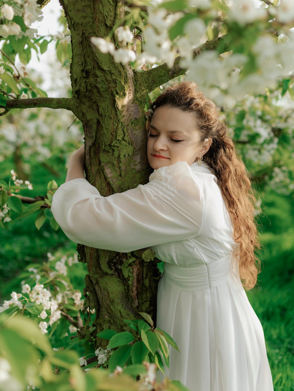 woman hugging a tree in spring